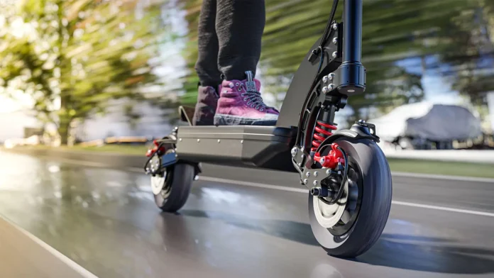 A photo of a man riding an e-scooter.